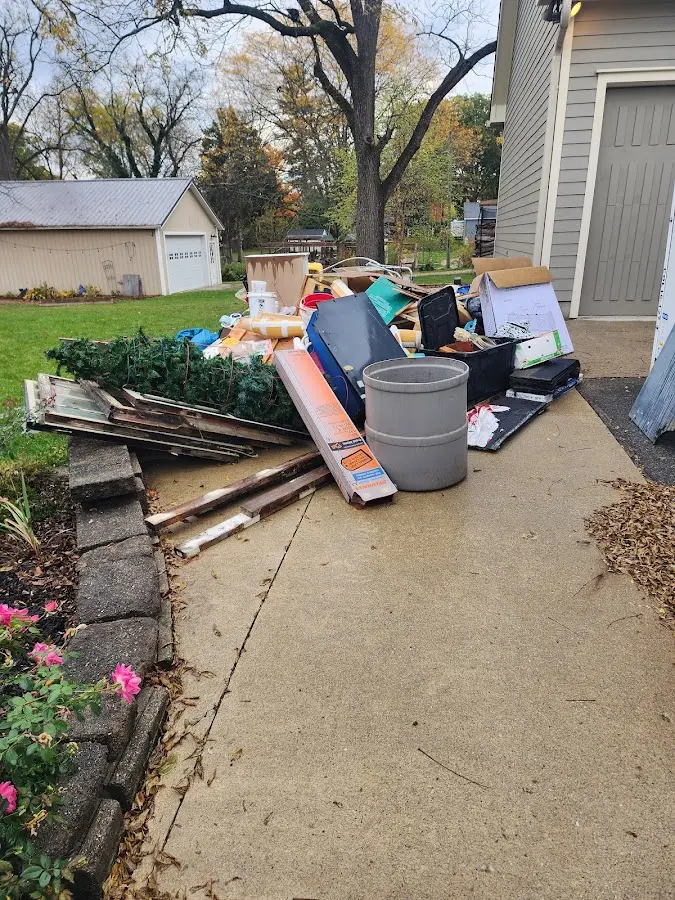 Dumpster being loaded with debris for 12 Yard Dumpster Rental in Iowa Colony